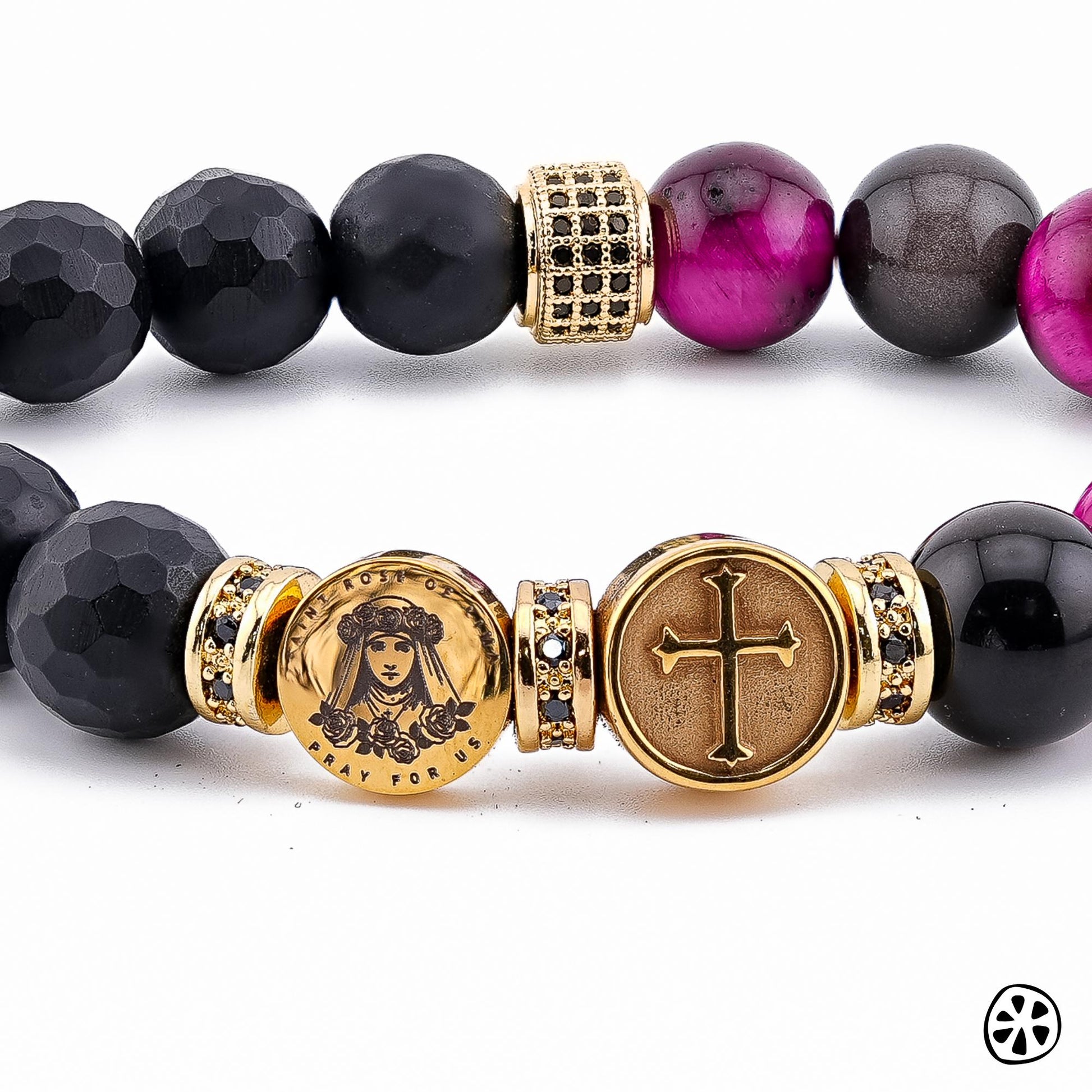 Handmade St. Rose of Lima & St. Martin de Porres Triple Protection Bracelet featuring 10mm black onyx matte beads, smooth gray obsidian, and genuine tiger eye coated in a pink-fuchsia tone. Adorned with 18K PVD gold-plated double-sided saint charms and gold CZ spacers. A unisex bracelet symbolizing faith, strength, and protection. / Pulsera artesanal de Santa Rosa de Lima y San Martín de Porres con ónix negro, obsidiana gris y ojo de tigre fucsia, hecha a mano en EE.UU.
