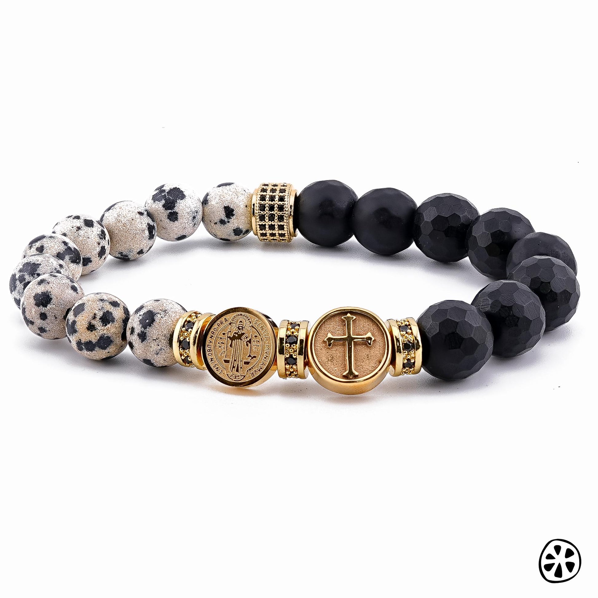 Handmade St. Benedict & Cross Protection Bracelet featuring 9–10mm Dalmatian Jasper and faceted black onyx matte beads. Adorned with 18K PVD gold-plated double-sided saint charms and gold CZ brass spacers. A unisex bracelet symbolizing strength, protection, and faith, handcrafted in the USA. / Pulsera artesanal de San Benito y Cruz de protección con jaspe dálmata y ónix negro mate, hecha a mano en EE. UU., símbolo de fe, fuerza y protección.