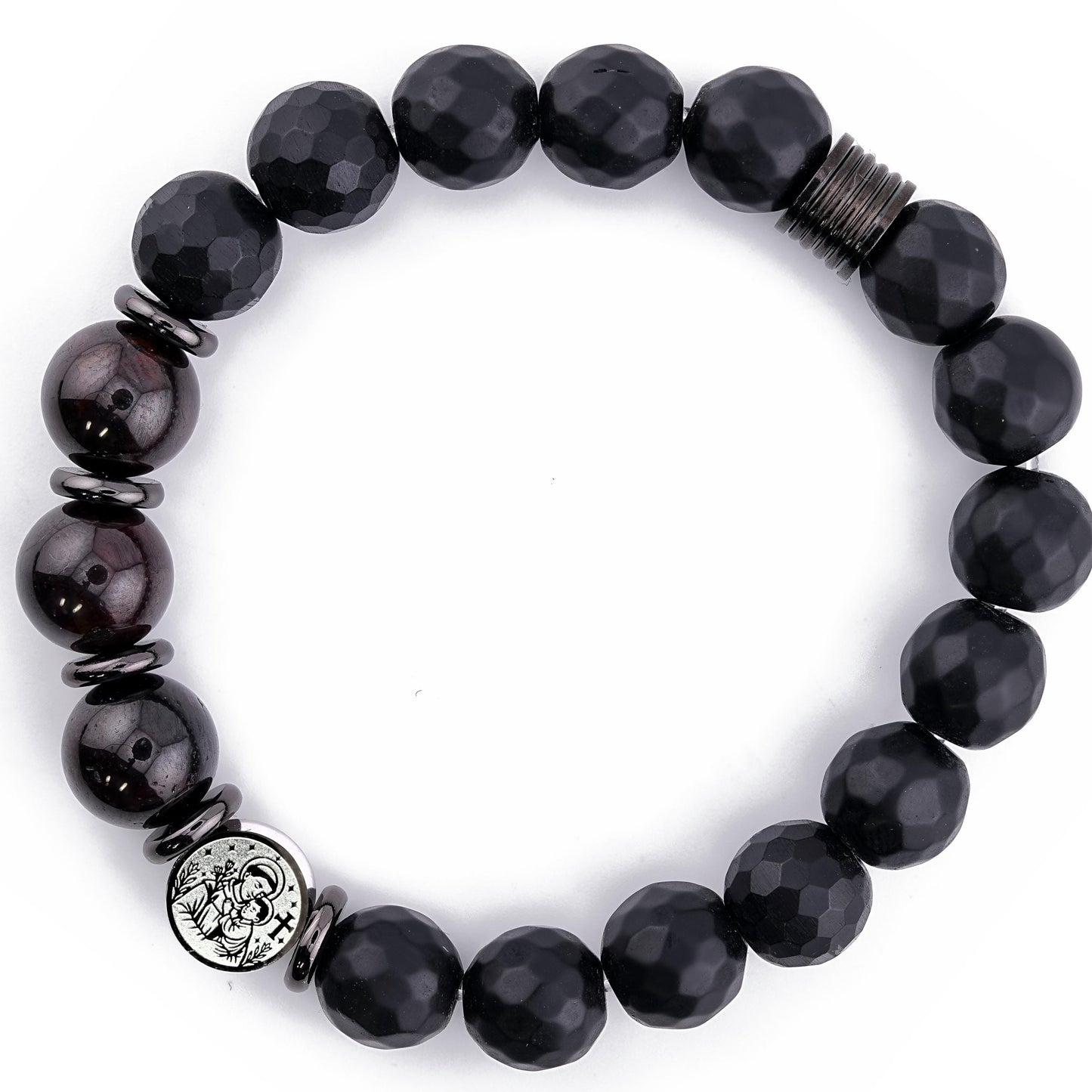 Minimalist product photo of a handmade St. Anthony of Padua bracelet featuring 10mm Black Faceted Onyx beads, deep Garnet stones, and tarnish-free stainless steel spacers. The double-sided St. Anthony medal is visible, highlighting its detailed engraving. Displayed on a bright white background, this unisex Catholic protection bracelet showcases its polished craftsmanship and elegant spiritual design.