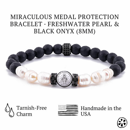 Product image of a Miraculous Medal protection bracelet featuring 8mm black onyx beads paired with natural freshwater pearls and a tarnish-free stainless steel Miraculous Medal charm. The bracelet is handmade in the USA and shown with matte and faceted onyx, decorative black spacers and pearl accents. Clean white background with icons indicating tarnish-free charm and handmade craftsmanship.”