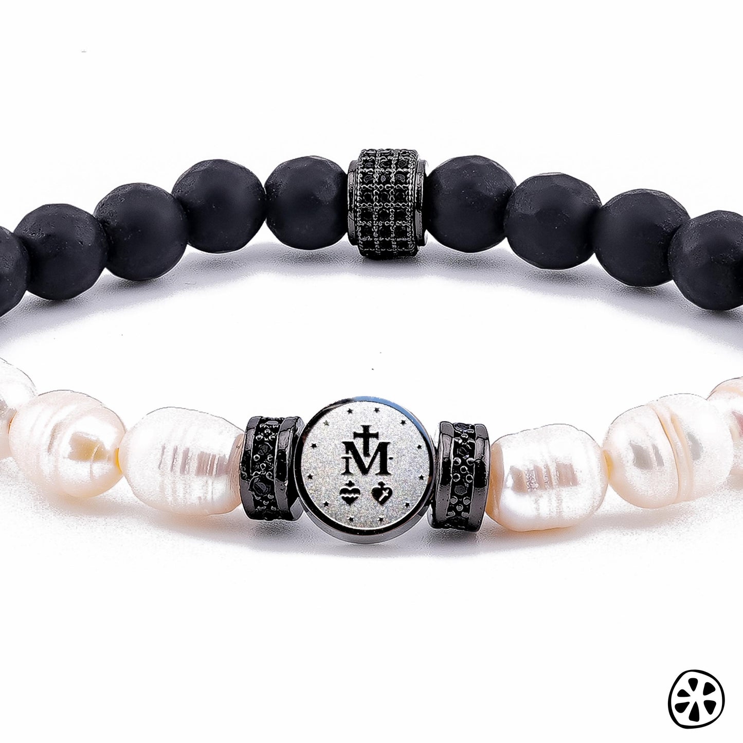 Close-up product image of a Miraculous Medal bracelet showing the double-sided stainless steel charm with the Marian symbol, framed by black CZ-accented brass spacers. The bracelet features matte black onyx beads and natural freshwater pearls, photographed on a clean white background with sharp detail on the textures and finishes. Catholic men’s religious bracelet and handmade faith accessory.