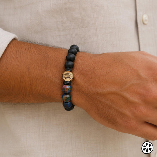 Guadalupe Virgin bracelet featuring a stainless steel 18K PVD gold plated 10mm medal with matte black onyx and cloisonné beads inspired by Our Lady of Guadalupe colors. Modern Catholic men’s bracelet for everyday wear and symbolic protection. Tarnish resistant stretch bracelet gift for boyfriend, husband, dad, first responder, police officer, nurse, EMT, confirmation, Father’s Day, birthday, or faith based gift. Contemporary unisex religious jewelry with artisan style.