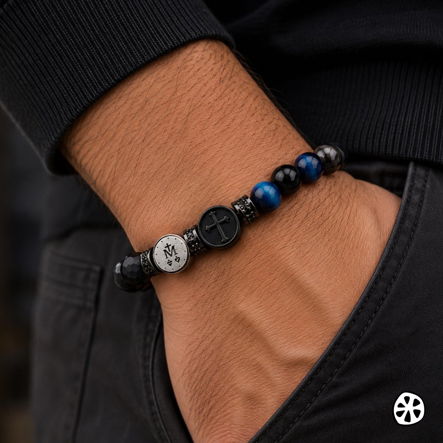 Miraculous Medal and cross bracelet for men featuring dual sided stainless steel medals, black CZ brass spacers, matte faceted black onyx, blue tiger eye, silver sheen obsidian and polished obsidian beads. Contemporary Catholic triple protection bracelet gift for caregivers, police officers, first responders and fathers. Durable tension elastic band bracelet with corrosion resistant materials for comfortable everyday wear. Masculine Christian jewelry handmade in the USA.